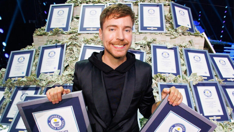 MrBeast in images with 50 world record plaques that Beast Games broke.