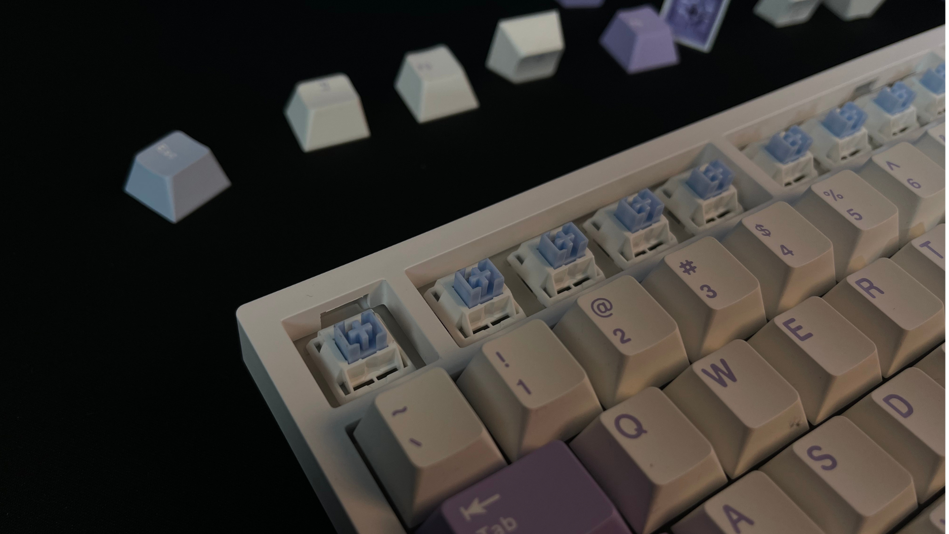 Remove the keycaps using keycap pullers and clean the plate