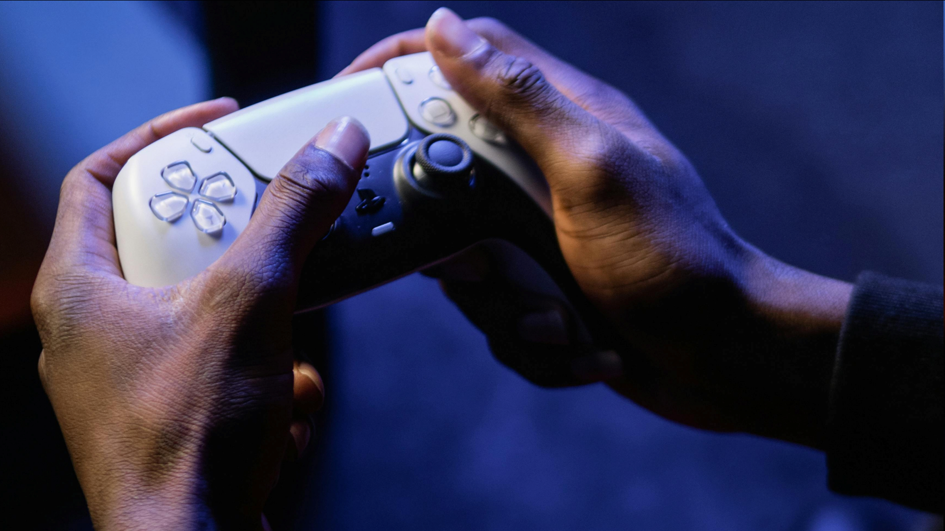 An image of a person holding a DualSense controller